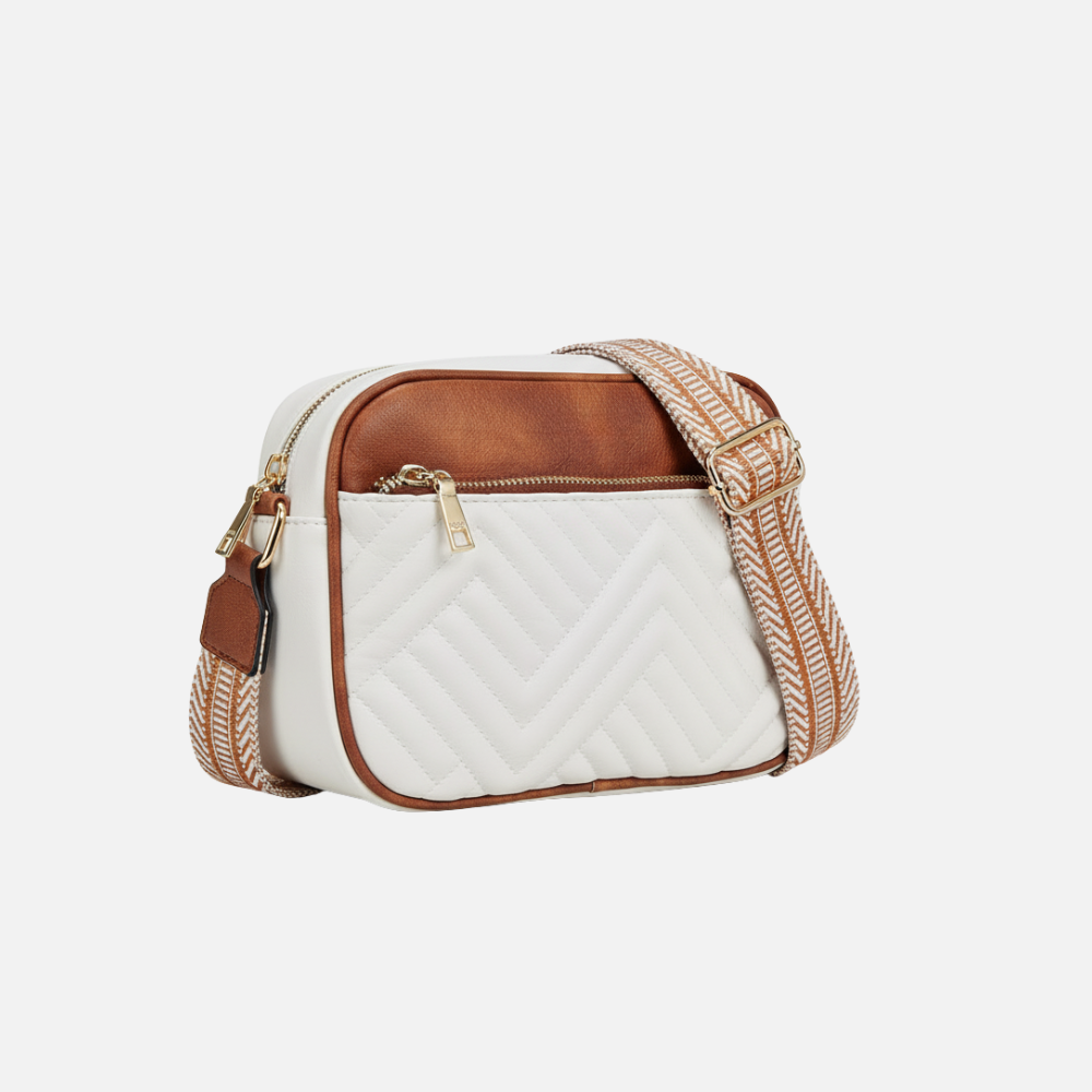 White quilted bag with brown accents on a light gray background
