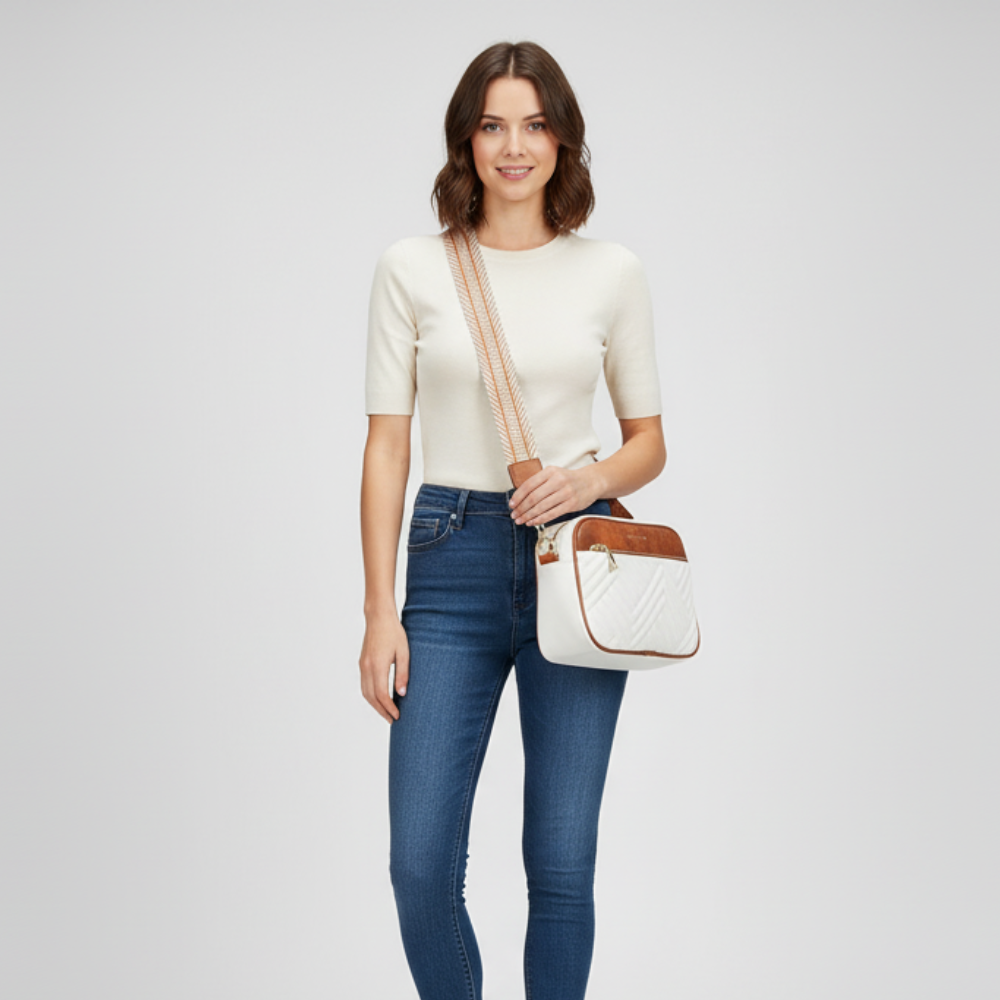 Woman holding a white handbag with brown accents on a light gray background